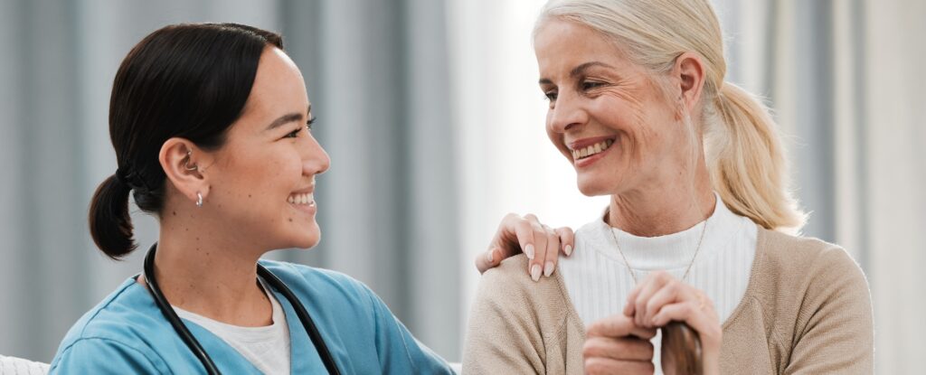 Nurse and senior woman offering support